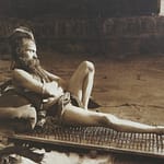 Fakir_on_bed_of_nails_Benares_India_1907